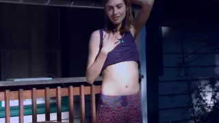 Cute Hippie Dancing In Skirt On Wooden Porch