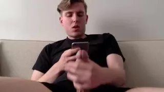 Horny blond guy jerks off his dick while chatting by phone