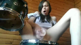 Teen fucks her pussy with big dildo on drumset