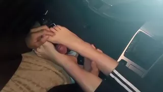 Girlfriend gives footjob in my car