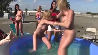 Naked pledgers wrestle in the pool