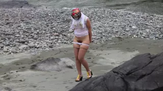 girlfriend in nylon pantyhose and heels posing by the river. a photo