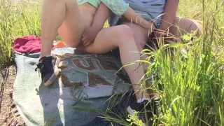 2 brunettes exploring each other in a grassy field