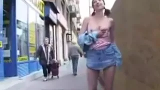 piss, crazy girl walking down the street among the numerous passers