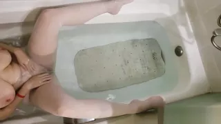 Erotic teen shows her perfect body in a bathtub while wearing white tights