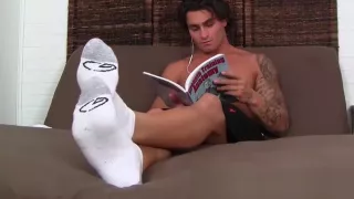 Cute brunette Vlad with tattoos shows off his feet