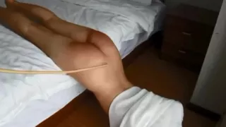 A slender girl endures a slender cane!