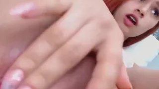 Teen redhead with braces fingers her pussy