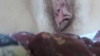 Nasty slut fingers her hairy pussy and squirts milk around