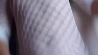 Horny brunette in a fishnet shirt playing with her pussy