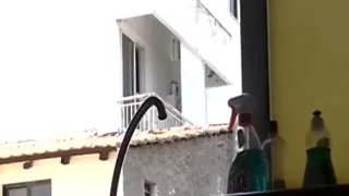 Sexy man smoking a cigarette and flashing his blonde neighbour