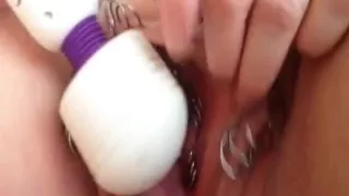Heavily pierced pussy gets played with a big fat vibrator