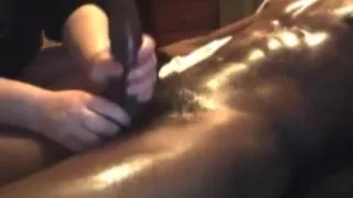 Oil massaging a big black cock and milking it