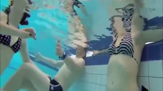 Cute girls in bikinis swimming and having fun in the pool