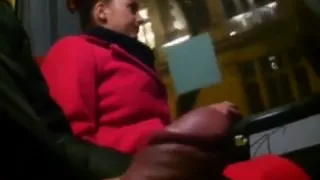 Young woman in a red coat on a bus