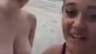 two friends sitting naked outside