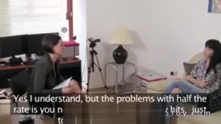 Female agent with strap on toy fucks babe