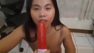 Pretty Asian Sucking On A Toy