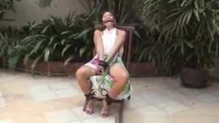 Asian teen tied up and hand cuffed on a chair