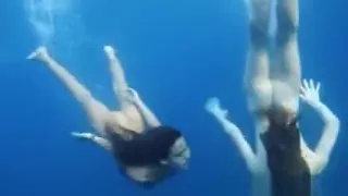 Nastya and Masha are swimming nude in the sea