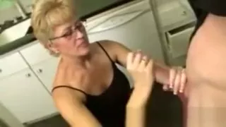 Mature in spex tugging dick for this very lucky guy