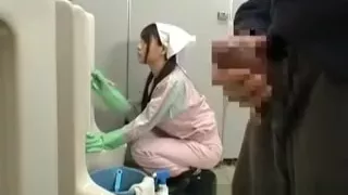 Asian bathroom attendant is in the mens