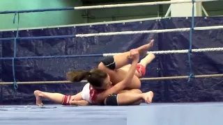 Muscular lesbians wrestling in a boxing ring