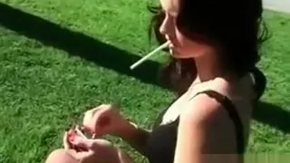Sexy brunette smoker gets outdoor