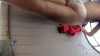 Long-legged beauty shows off her delicious butt while in th