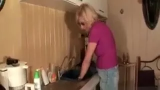 Mature housekeeper teasing her hot snatch in the kitchen