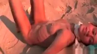 Sensual Natasha touching her naked body in the sand