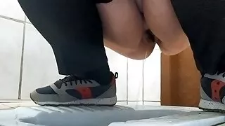 Curvy MILF pissing in a dirty public toilet