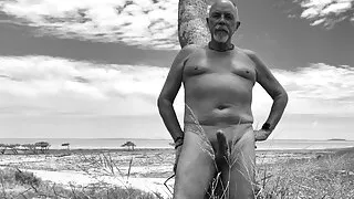 Playing outside at the beach nude and erect