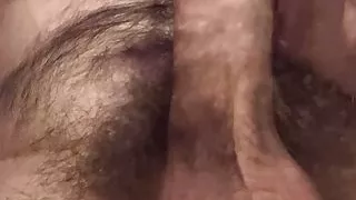 Laying in bed, playing with and showing the underside my very hairy shaft and balls until I cum on my chest