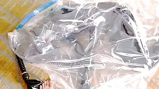 Fejira com Leather-clad girl wrapped in a plastic bag