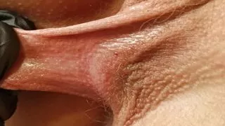 Pulling and stretching her labia
