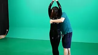 Fejira com Latex-clad woman tied and hung up to be fondled and whipped