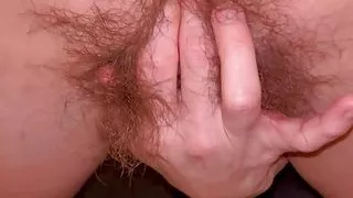 Hairy Sara fingers her hairy bush from behind