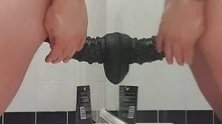 Carl cagedwarrior takes huge BBC dildo in hotel bathroom with mirror reflection
