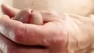 Bearded man jerks cock close up