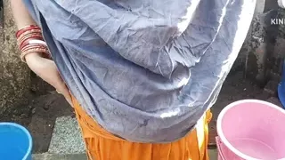 Indian house wife bathing outside