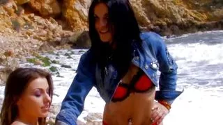 Two sunning German chicks enjoy riding a loaded cock on the beach