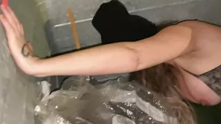 Nasty street girl in the dumpster stripping
