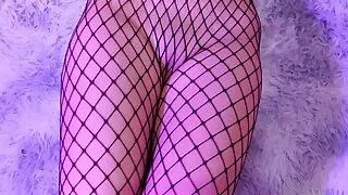 Asian in fishnet gives a footjob and gets cum all over her pussy