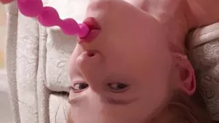 She felt bad sucking a dildo in such a difficult pose