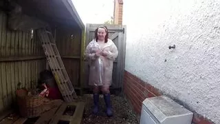 sexy wife Haley outdoors in plastic mac and Wellingtons