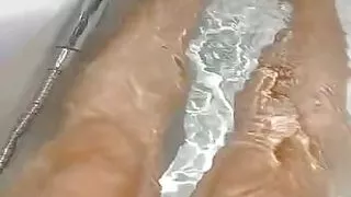 Sexy hot girl leg playing on bath tab.