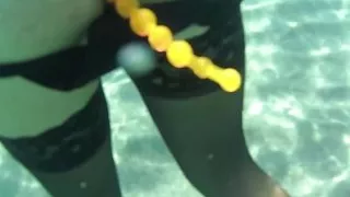 black stocking and anal beads in the sea