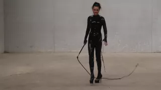 The Goddess Obsidian Wields Her Bullwhips Ominously In Her Latex Catsuit