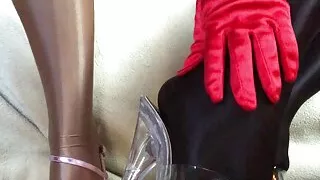 Sensual teasing close up legs and feet in Shiny glossy pantyhose and high heels.